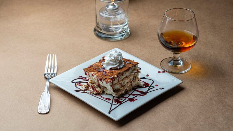 Tiramisu cake topped with whipped cream