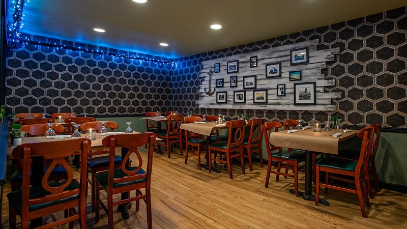 Dining room area with six set tables with seating for four